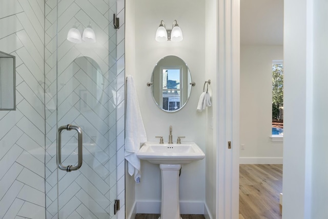 bathroom featuring a shower with door and hardwood / wood-style flooring