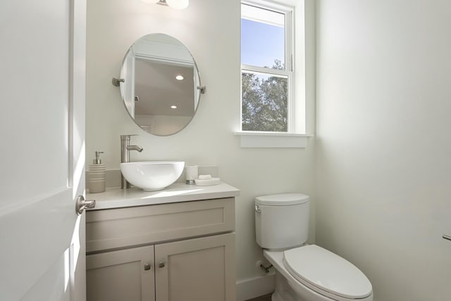 bathroom with toilet and vanity