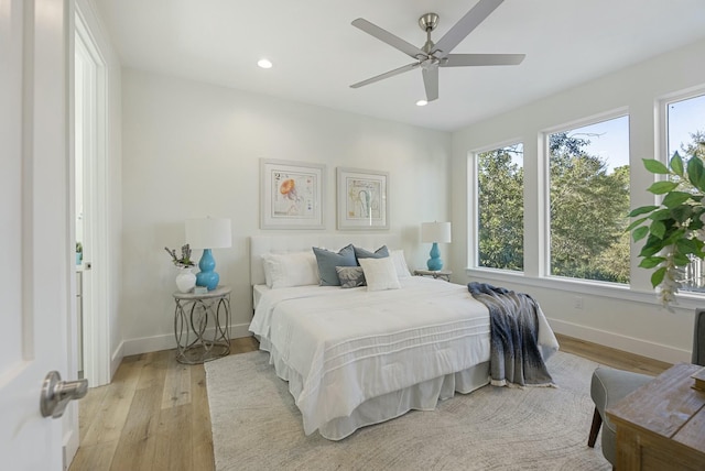 bedroom with light wood-type flooring and ceiling fan