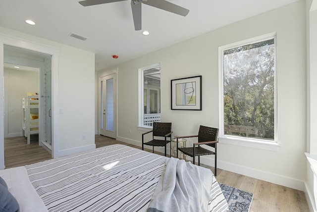 bedroom with ceiling fan and light hardwood / wood-style flooring