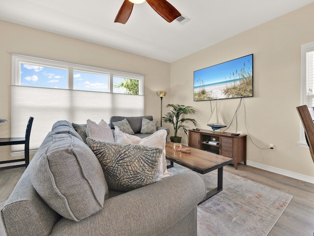 living room featuring ceiling fan and light hardwood / wood-style floors