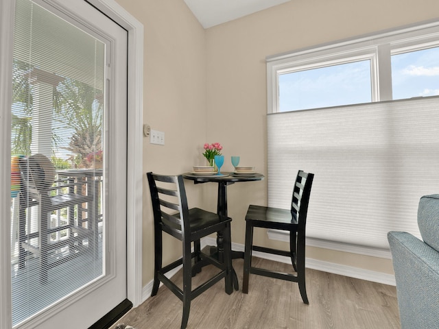 dining area featuring light wood-type flooring and a healthy amount of sunlight