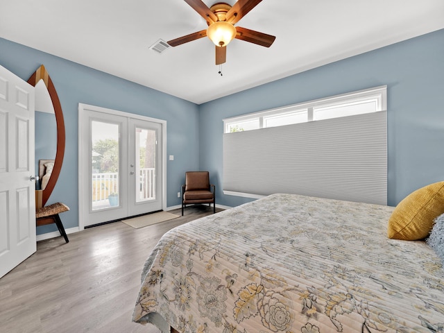 bedroom featuring access to exterior, french doors, light hardwood / wood-style flooring, and ceiling fan