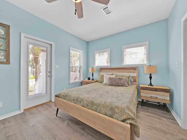 bedroom featuring light wood-type flooring, access to outside, and ceiling fan