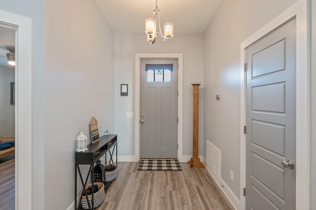 entrance foyer featuring light hardwood / wood-style flooring and an inviting chandelier