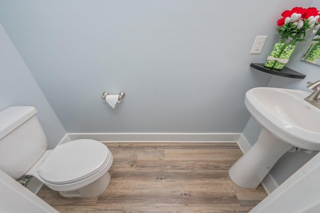 bathroom featuring hardwood / wood-style floors and toilet