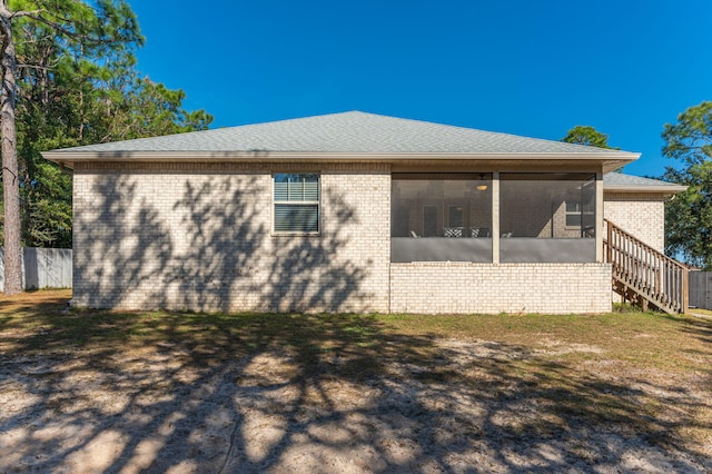 back of house with a sunroom and a yard