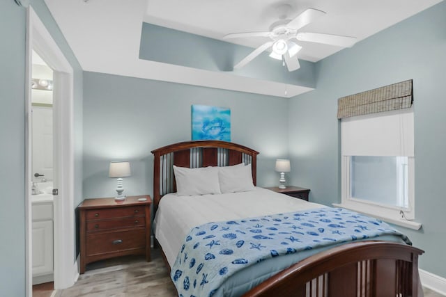 bedroom featuring connected bathroom, ceiling fan, and light hardwood / wood-style floors