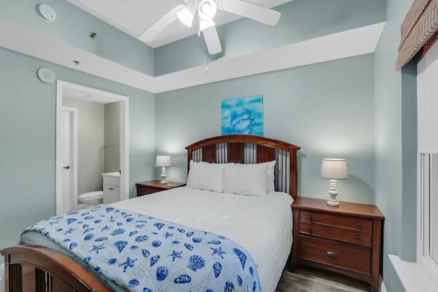 bedroom featuring connected bathroom, ceiling fan, and hardwood / wood-style flooring