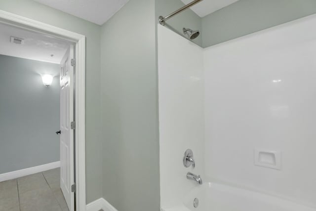 bathroom with tile patterned flooring and bathtub / shower combination