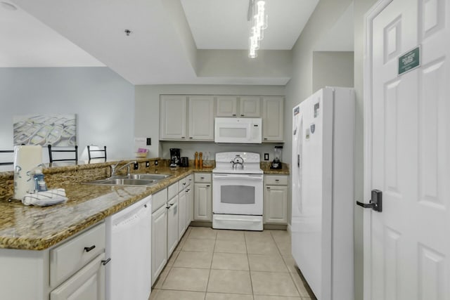 kitchen with sink, kitchen peninsula, pendant lighting, white appliances, and light tile patterned floors