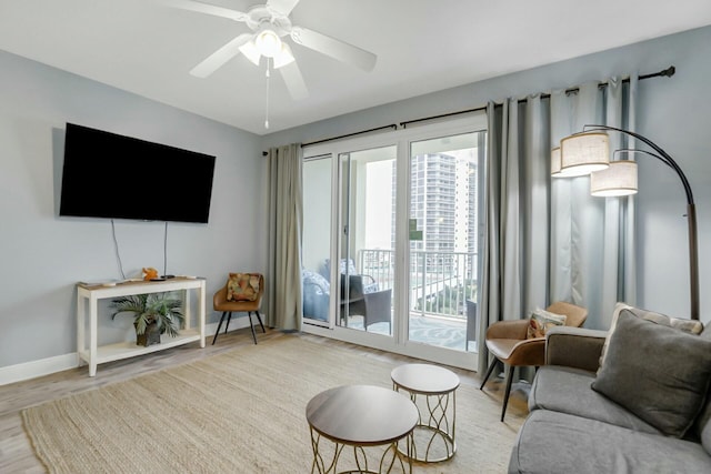 living room featuring light hardwood / wood-style flooring and ceiling fan