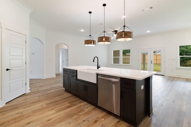 kitchen featuring arched walkways, visible vents, dishwasher, ornamental molding, and light countertops