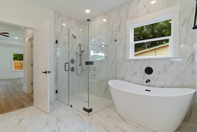 bathroom featuring recessed lighting, marble finish floor, a freestanding bath, and a marble finish shower