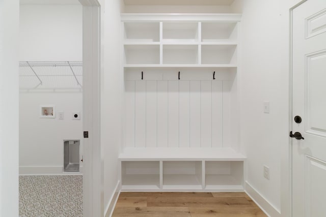 mudroom featuring light wood finished floors and baseboards