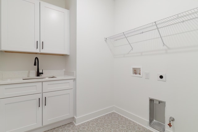 laundry room featuring cabinet space, baseboards, a sink, washer hookup, and electric dryer hookup