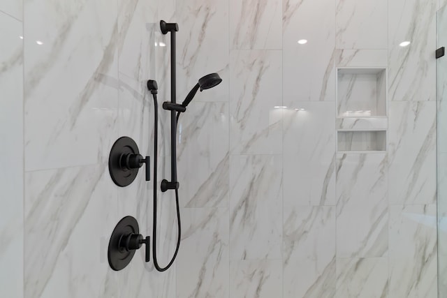 details featuring a marble finish shower