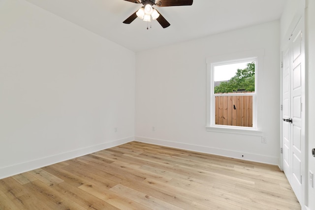 unfurnished room with ceiling fan, light wood-type flooring, and baseboards