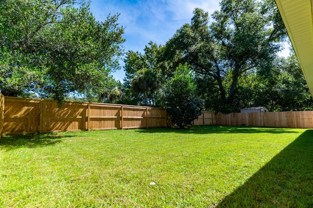 view of yard with a fenced backyard