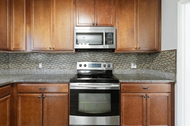 kitchen with backsplash, light stone countertops, and appliances with stainless steel finishes