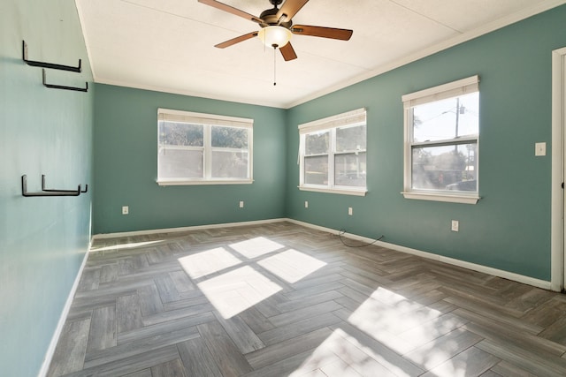 spare room with ceiling fan, crown molding, and parquet flooring