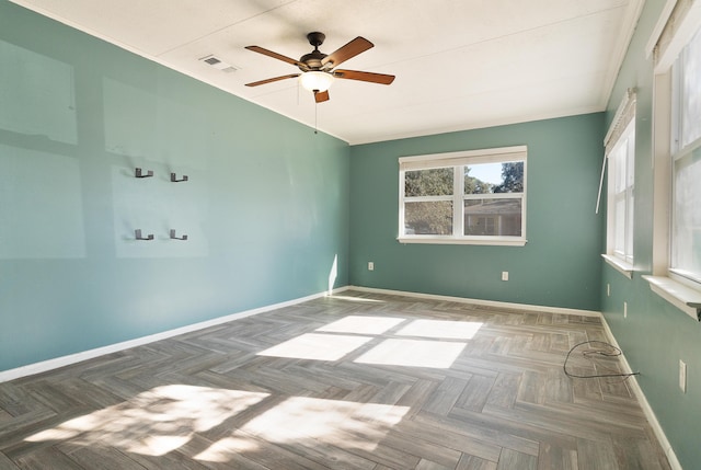 empty room featuring parquet flooring and ceiling fan