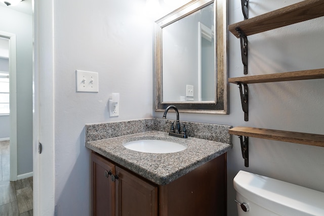 bathroom featuring vanity and toilet