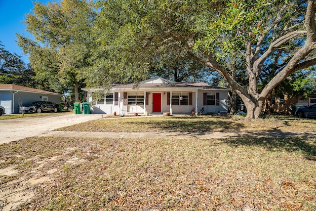 ranch-style home with a front lawn and covered porch