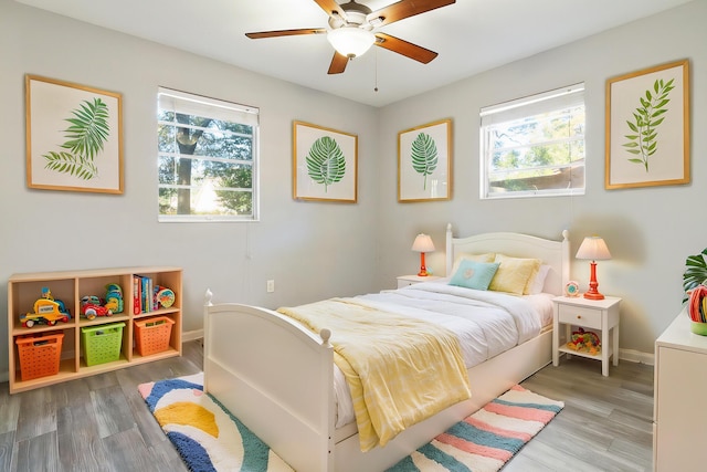 bedroom with light hardwood / wood-style flooring and ceiling fan