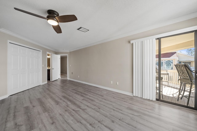 unfurnished bedroom with access to exterior, ceiling fan, light hardwood / wood-style flooring, crown molding, and a closet