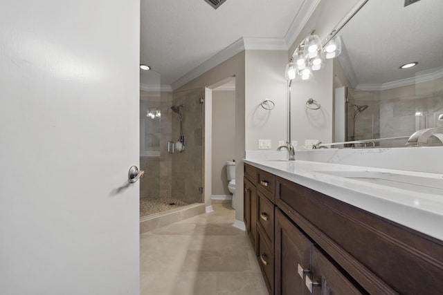 bathroom featuring vanity, toilet, an enclosed shower, and ornamental molding