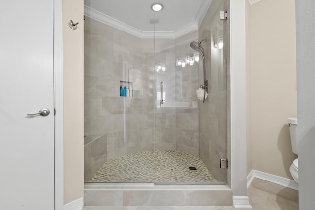 bathroom with toilet, a shower with shower door, and crown molding