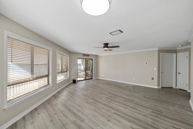 unfurnished living room featuring ceiling fan, crown molding, and light wood-type flooring