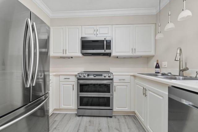 kitchen with white cabinetry, sink, stainless steel appliances, light hardwood / wood-style flooring, and decorative light fixtures