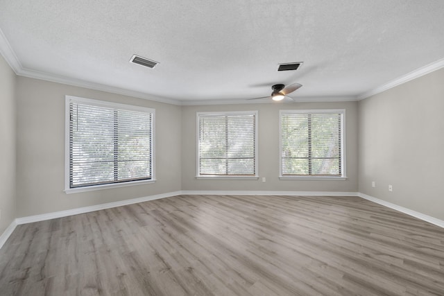 spare room with a textured ceiling, light wood-type flooring, ceiling fan, and ornamental molding