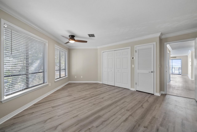 unfurnished bedroom with ceiling fan, light hardwood / wood-style floors, ornamental molding, and multiple windows