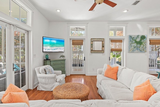 living room featuring ceiling fan and light wood-type flooring