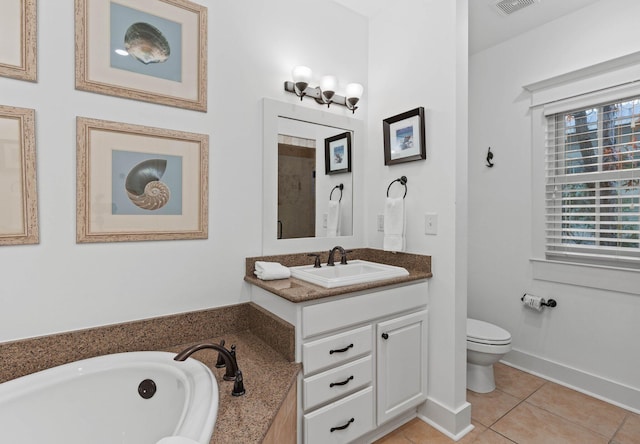 bathroom with tile patterned flooring, vanity, toilet, and a washtub