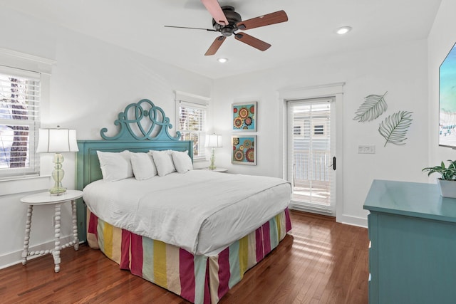 bedroom with multiple windows, ceiling fan, and dark wood-type flooring