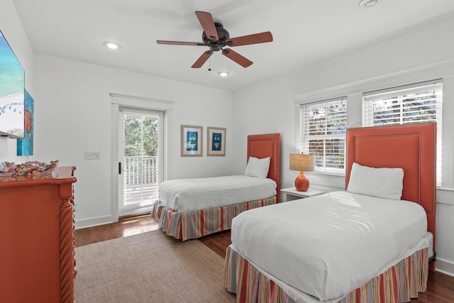 bedroom featuring ceiling fan, access to exterior, and dark wood-type flooring