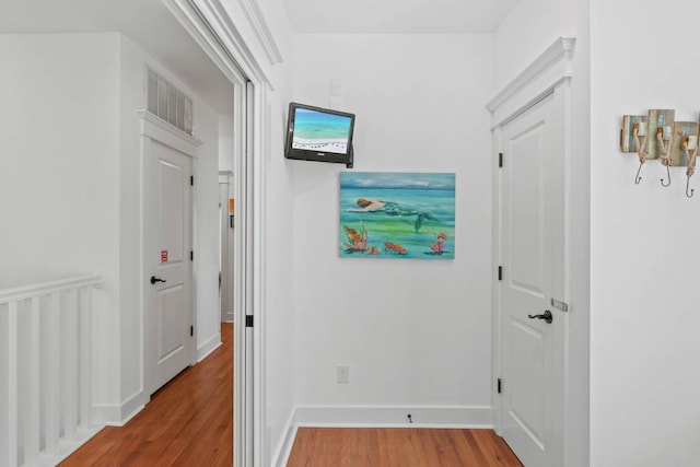 corridor featuring hardwood / wood-style floors