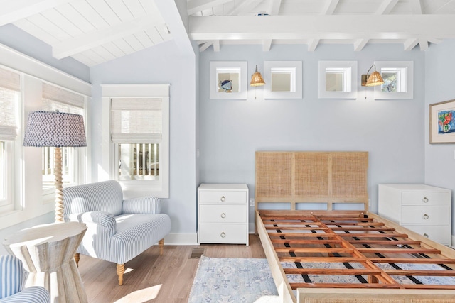 bedroom featuring vaulted ceiling with beams, light hardwood / wood-style flooring, and wooden ceiling