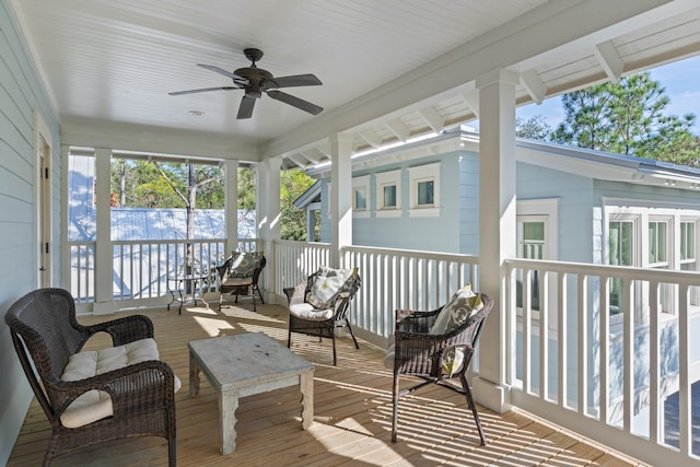 sunroom / solarium featuring ceiling fan