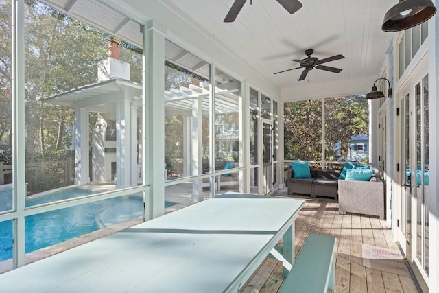 sunroom / solarium featuring ceiling fan