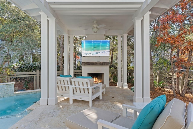 view of patio featuring an outdoor living space with a fireplace and ceiling fan