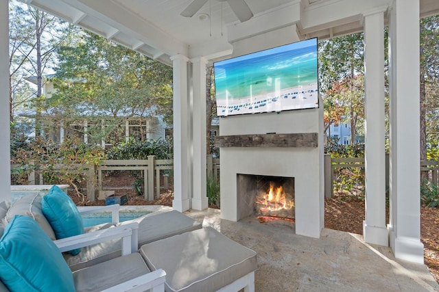 view of patio / terrace featuring ceiling fan and an outdoor fireplace