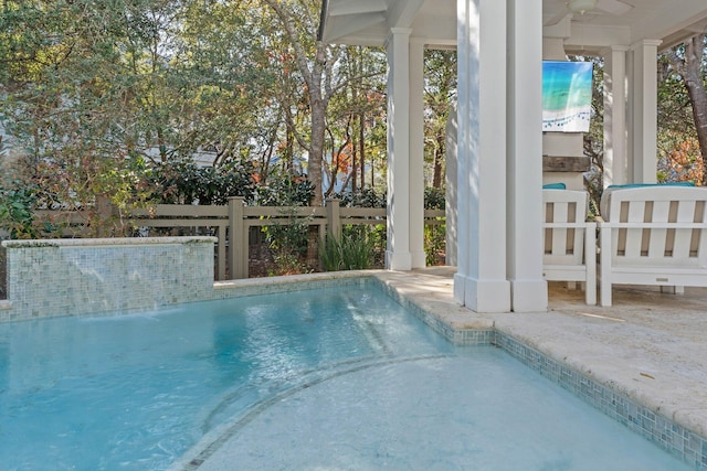 view of swimming pool with pool water feature