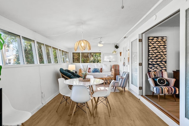 sunroom / solarium featuring ceiling fan