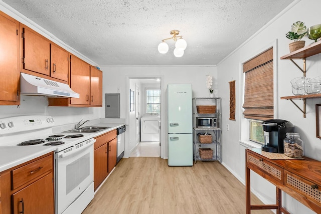 kitchen with white appliances, washer / clothes dryer, crown molding, sink, and electric panel