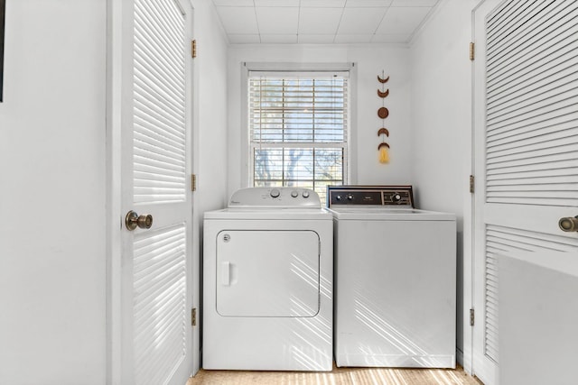 clothes washing area with separate washer and dryer